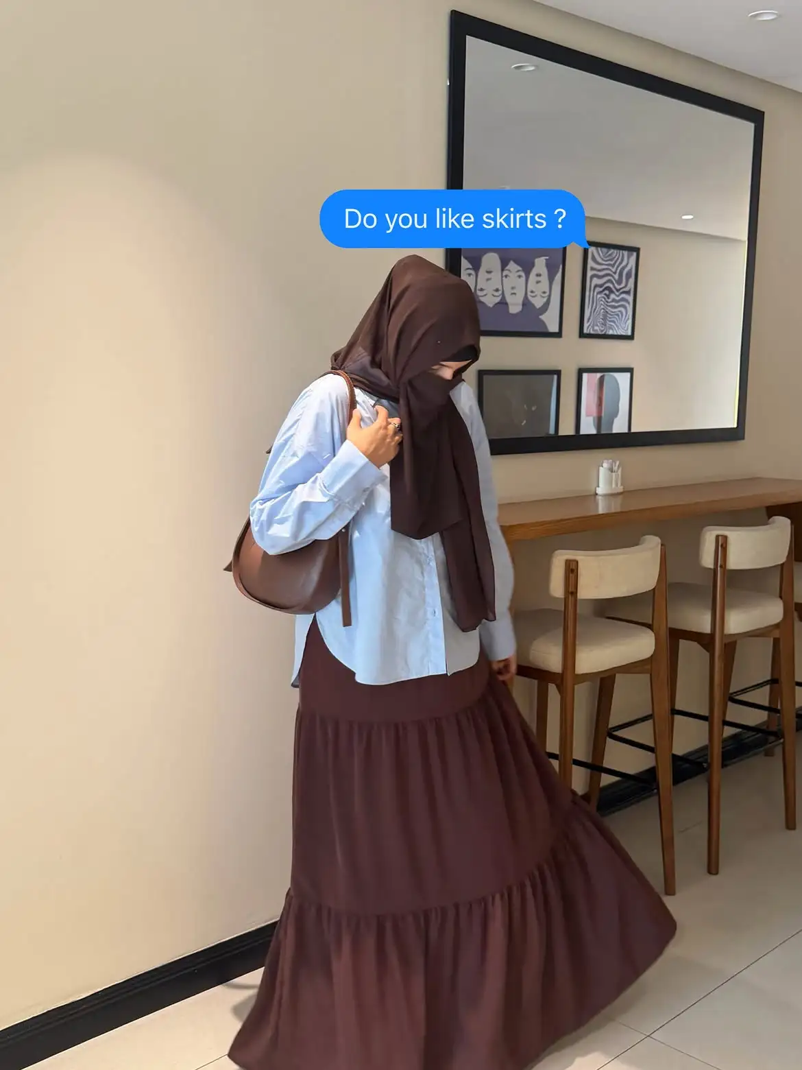 Side view of a brown three layer skirt for women with a flowy tiered silhouette.